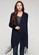 [Color: Midnight] A brunette woman wearing a navy blue cardigan with fringe details.