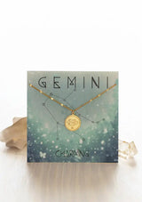[Zodiac Sign: Gemini] Gold necklace on an Gemini-themed card with celestial design