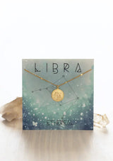 [Zodiac Sign: Libra] Gold necklace on a Libra-themed card with celestial design