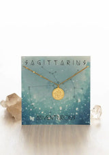 [Zodiac Sign: Sagittarius] Gold necklace on a Sagittarius-themed card with celestial design