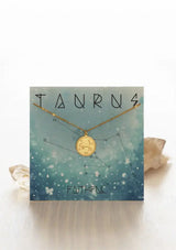 [Zodiac Sign: Taurus] Gold necklace on an Taurus-themed card with celestial design