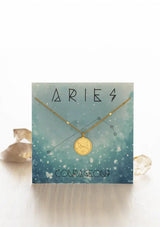 [Zodiac Sign: Aries] Gold necklace on an Aries-themed card with celestial design