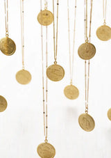 [Zodiac Sign: Aquarius] Gold necklaces with coin pendants on a white background