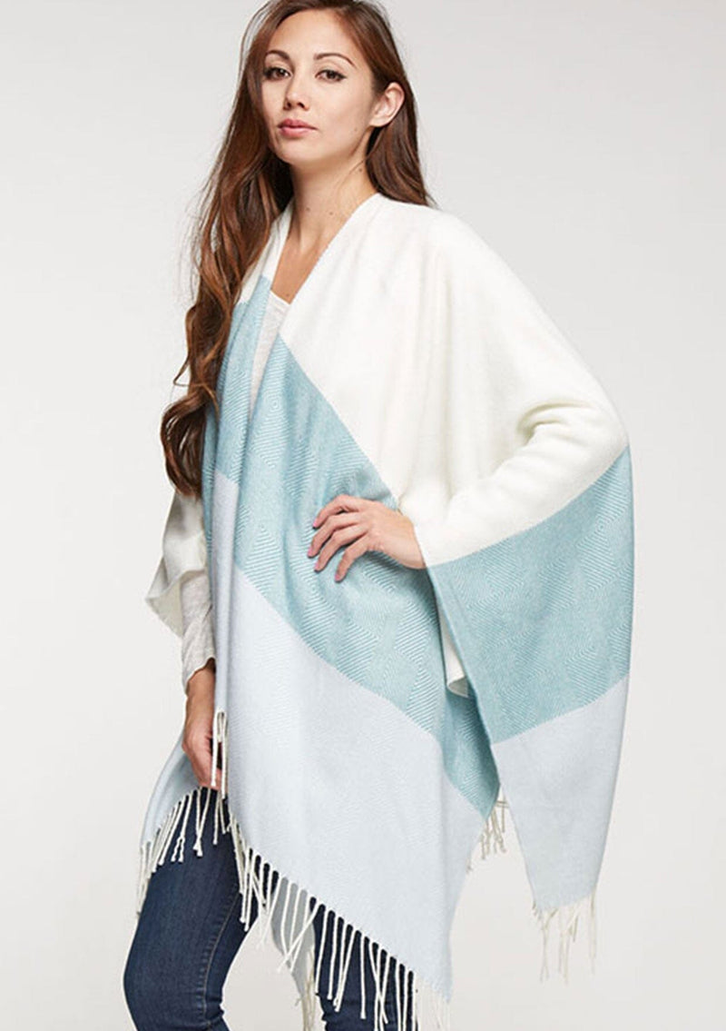 [Color: Vanilla/Mint] A bohemian fringed poncho in an ivory and mint block stripe.