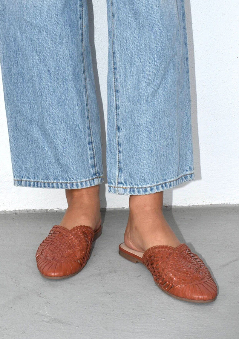 [Color: Cognac] Handwoven leather basketweave slip on mules in cognac brown. With a braided topline and flat rubber sole. Sustainably and ethically made in India. 
