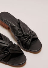 A pair of black leather heels with a small block heel and a twist detail 