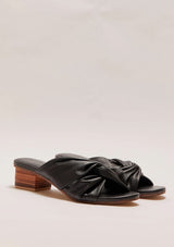 A pair of black leather heels with a small block heel and a twist detail 