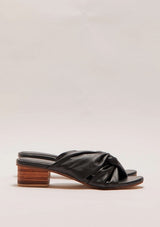 A pair of black leather heels with a small block heel and a twist detail 