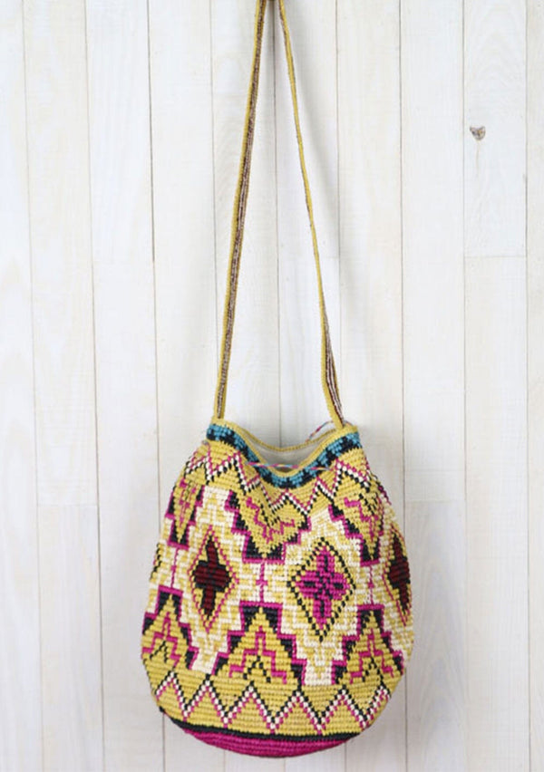 [Color: Mustard/Fuchsia] A brightly colorful roomy bohemian bucket bag made with raffia. With a thick shoulder strap, an adjustable drawstring closure, and oversized tassel accents. 