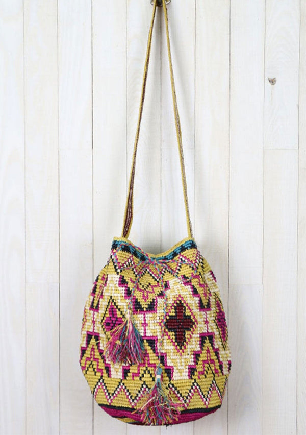 [Color: Mustard/Fuchsia] A brightly colorful roomy bohemian bucket bag made with raffia. With a thick shoulder strap, an adjustable drawstring closure, and oversized tassel accents. 