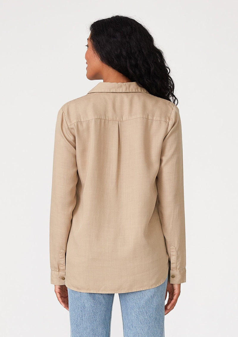 [Color: Sand] A back facing image of a brunette model wearing a relaxed fit khaki shirt. With long sleeves, a collared neckline, a button front, and front patch pockets. 