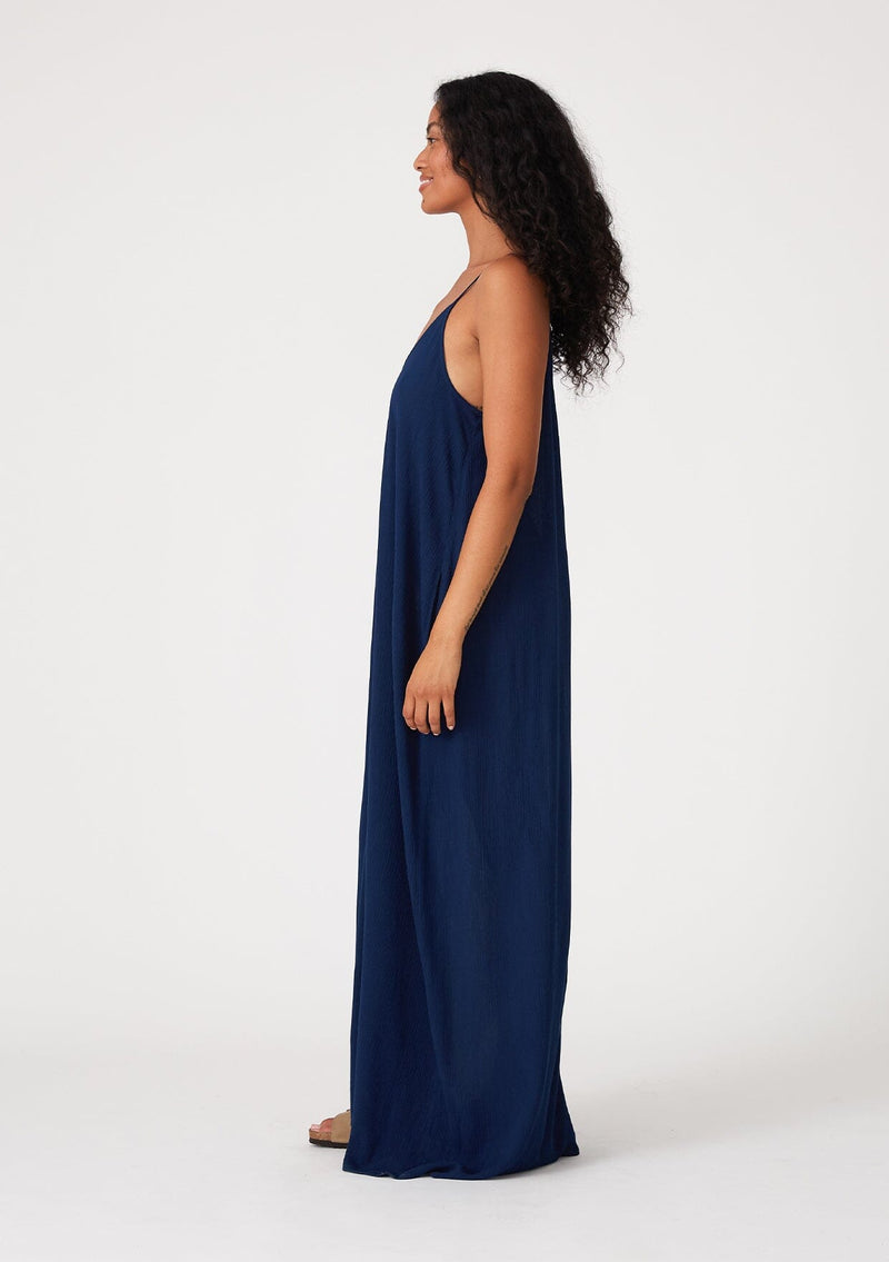 [Color: Pacific Blue] A navy blue harem maxi dress. This billowy maxi tank top dress features a deep v neckline, adjustable spaghetti straps, and a cocoon fit.