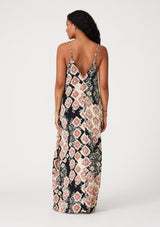 [Color: Black/Dusty Rose] A back facing image of a brunette model wearing a best selling black and pink bohemian printed maxi dress. With adjustable spaghetti straps, a deep v neckline in front and back, a flowy, oversize cocoon fit, and side pockets.