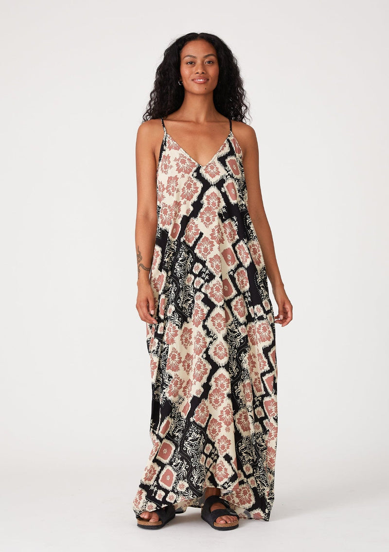 [Color: Black/Dusty Rose] A front facing image of a brunette model wearing a best selling black and pink bohemian printed maxi dress. With adjustable spaghetti straps, a deep v neckline in front and back, a flowy, oversize cocoon fit, and side pockets.