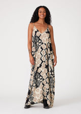 [Color: Black/Khaki] A front facing image of a brunette model wearing a best selling black and beige bohemian printed maxi dress. With adjustable spaghetti straps, a deep v neckline in front and back, a flowy, oversize cocoon fit, and side pockets.