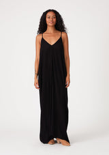 [Color: Black] A black harem maxi dress. This billowy maxi tank top dress features a deep v neckline, adjustable spaghetti straps, and a cocoon fit.