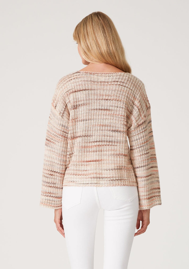 [Color: Dusty Blush] A back facing image of a blonde model wearing a cropped bohemian sweater in a pink and brown multi color space dye knit. With long bell sleeves and a wide boat neckline.