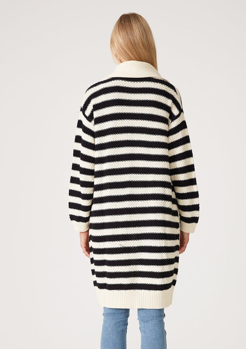 [Color: Black/White] A back facing image of a blonde model wearing a mid length cardigan in a black and white stripe. With long sleeves, a collared neckline, an open front, and side pockets.