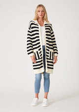 [Color: Black/White] A full body front facing image of a blonde model wearing a mid length cardigan in a black and white stripe. With long sleeves, a collared neckline, an open front, and side pockets.