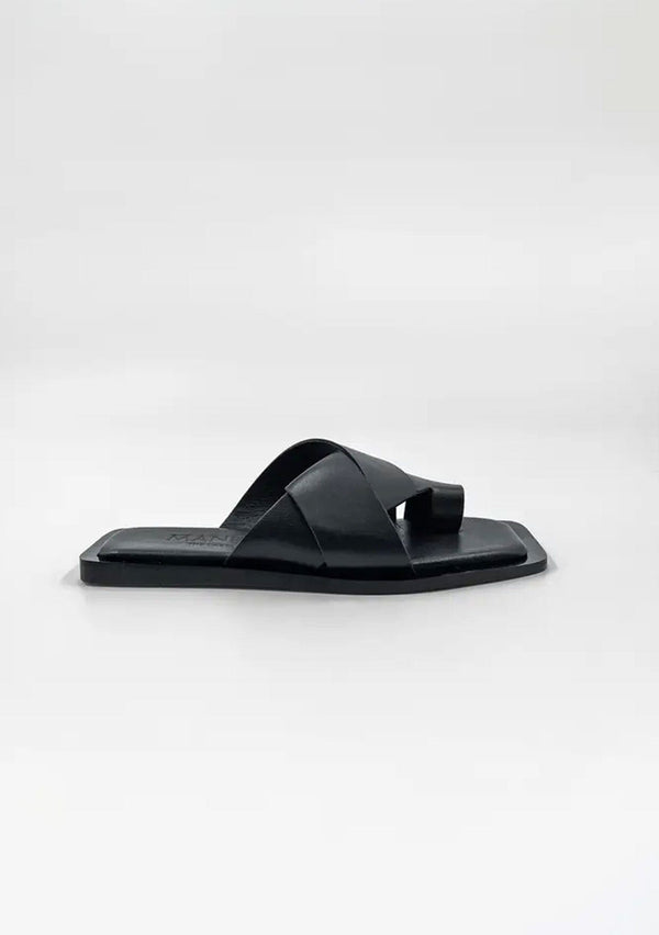 [Color: Black] A simple and sophisticated black leather flat slip on sandal with a toe hold. 