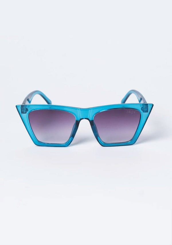 [Color: Blue] A pair of oversized clear blue acetate frames with sharp edges, from INDY. 