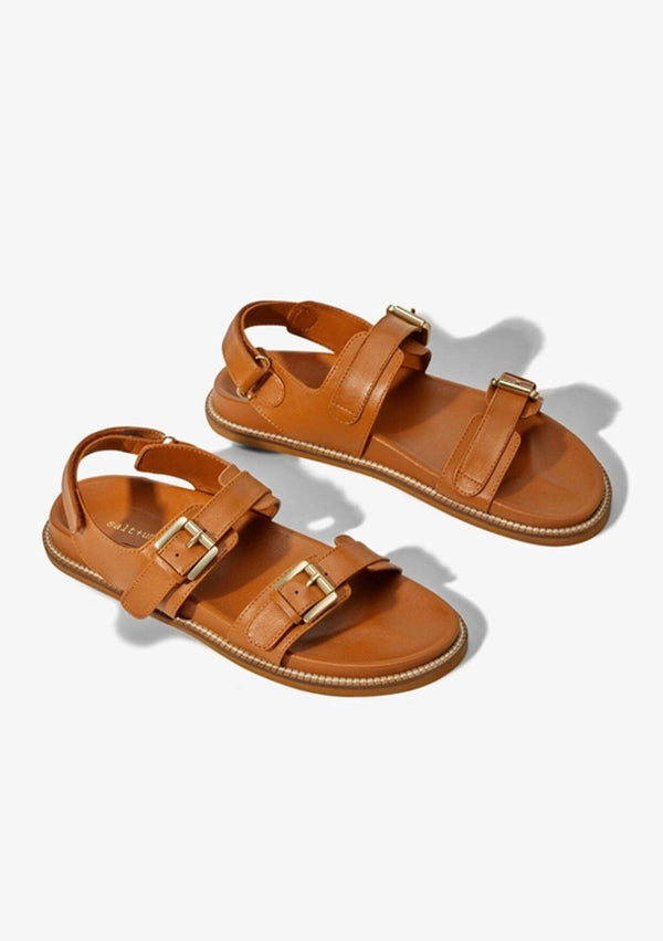 [Color: Tan] A classic brown leather buckle sandal made from one hundred percent upcycled materials. With two adjustable top buckle straps and an adjustable back Velcro strap. Sustainably and ethically made in India. 