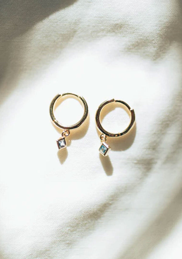 Simple gold hoop earrings with an eye catching aquamarine stone. 