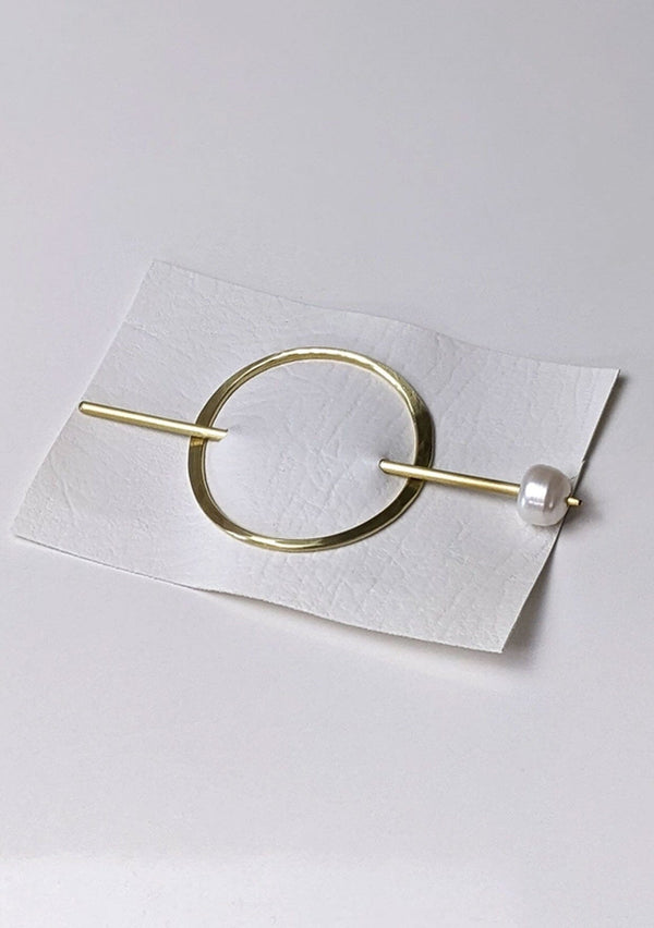 [Color: Cream] A classic brass hairpin with a cream pearl accent. 