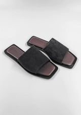 [Color: Dark Brown Suede] A pair of simple, minimalist flat slide sandals in dark brown suede. 