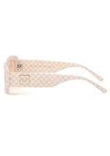 [Color: Beige] The Dolly sunglasses by INDY eyewear in a beige and white checkered design. In a rounded rectangle frame. 
