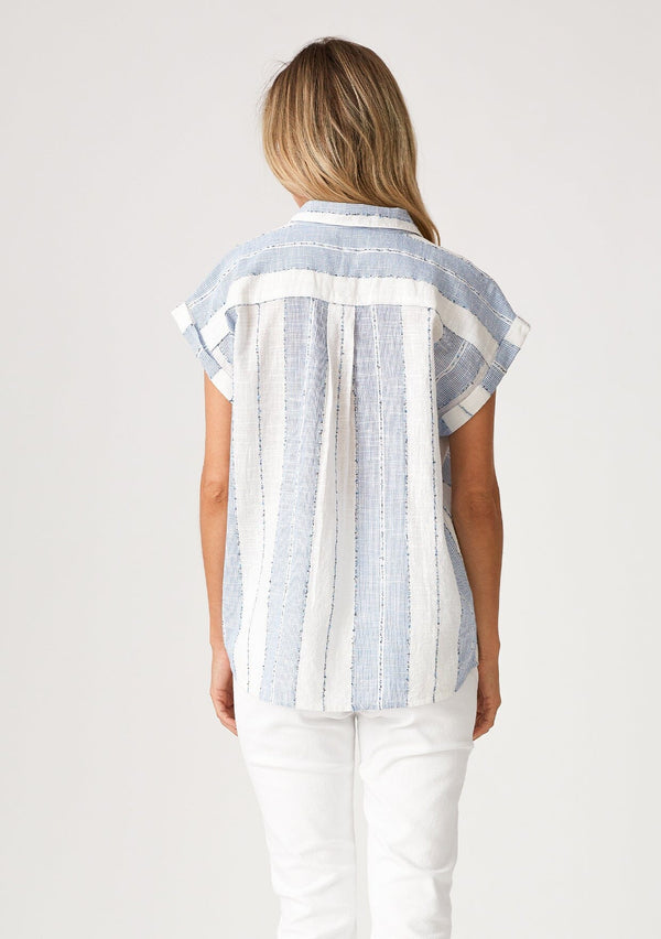 [Color: White/Blue] A back facing image of a blonde model wearing a white and blue striped shirt with short cuffed sleeves, a button front, a classic collared neckline, and a front patch pocket.