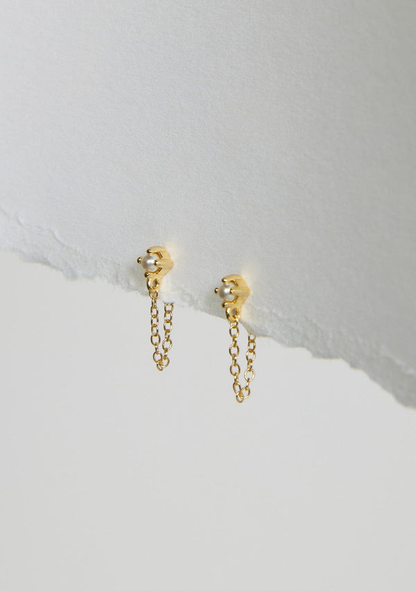 A delicate chain stud earring with a freshwater pearl accent. Made with fourteen karat gold plating on sterling silver. Hypoallergenic and made in the USA. 