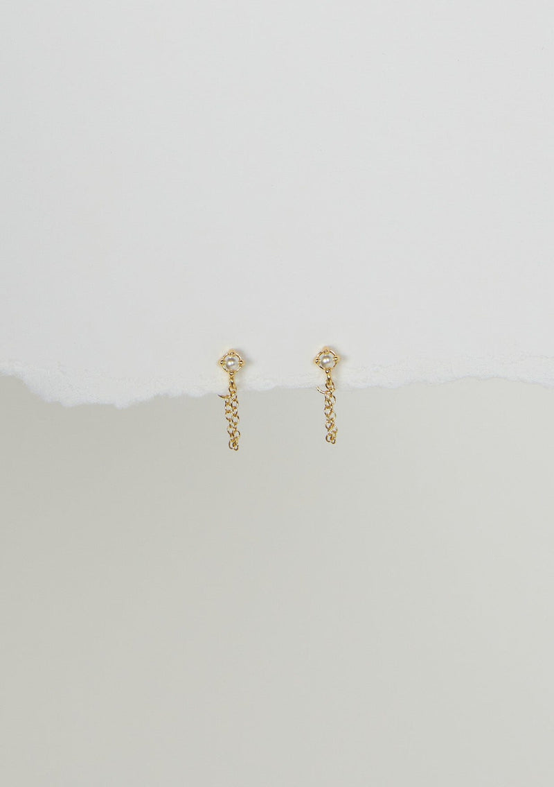 A delicate chain stud earring with a freshwater pearl accent. Made with fourteen karat gold plating on sterling silver. Hypoallergenic and made in the USA. 