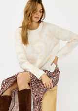 [Color: Ivory/Light Blush] A front facing image of a blonde model wearing cozy knit sweater with a floral jacquard pattern. Featuring a classic crew neckline, cozy long sleeves, and ribbed trims. A fall trending sweater for cold weather styling. 