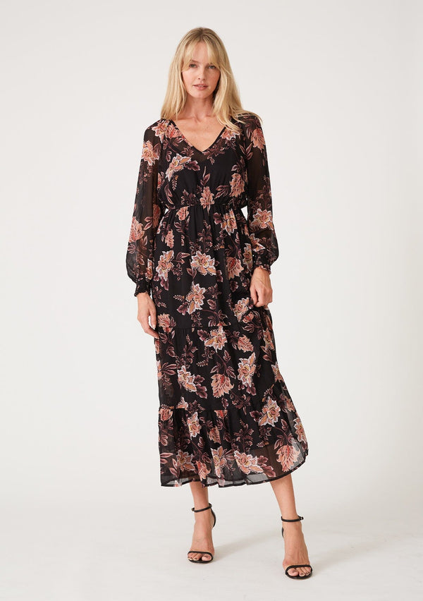 [Color: Black/Dusty Coral] A front facing image of a blonde model wearing a bohemian black and coral floral print chiffon maxi dress. With voluminous long sleeves, a v neckline, a flowy tiered skirt, and an elastic waist.