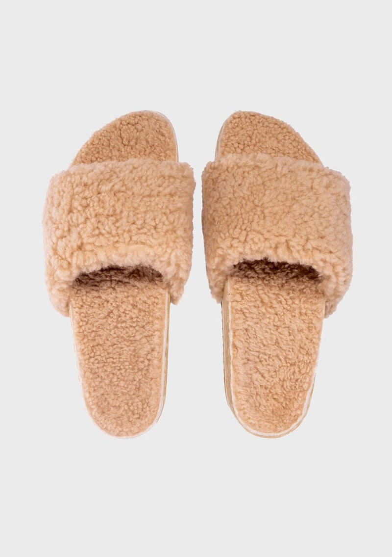 [Color: Sand] An image of a fuzzy shearling slide sandal in beige with a thick platform sole. Designed with sustainability in mind from Fleks footwear. 