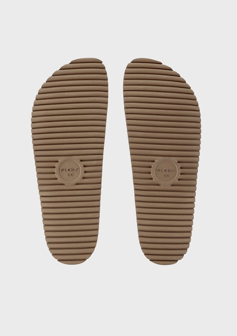 [Color: Sand] An image of the bottom of a fuzzy shearling slide sandal in beige with a thick platform sole. Designed with sustainability in mind from Fleks footwear. 