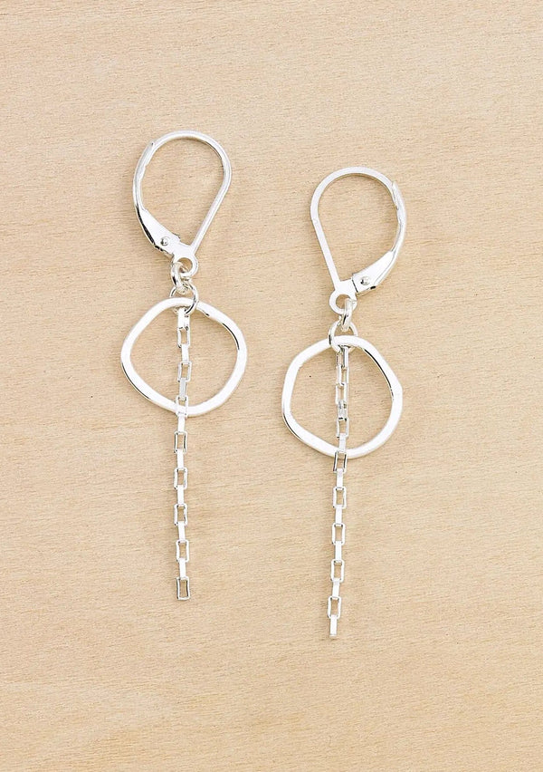 Pair of silver earrings with a small hammered circle and chain drop detail. Attached to a round wire lever back. 