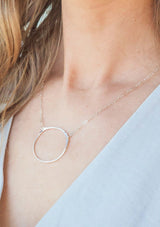 Sterling silver necklace with a hammered circular pendant.
