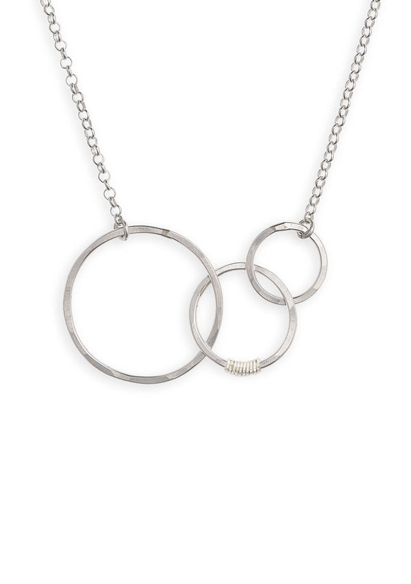 A sterling silver necklace with hammered interlocking circles suspended by a 16 inch chain. 