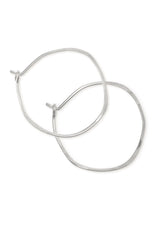 Sterling silver hoop earrings hammered into an imperfect circle.