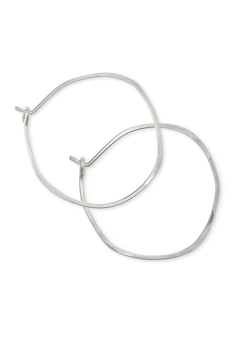 Sterling silver hoop earrings hammered into an imperfect circle.