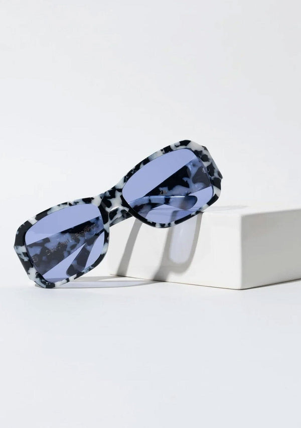 [Color: Blue] An oversized pair of sunglasses with a rectangular frame, made with biodegradable acetate and polarized blue lenses. 