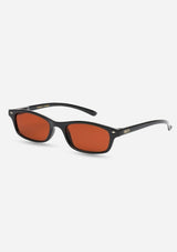 [Color: Black] A pair of slim, rectangle black acetate frames with amber lenses. Made by INDY