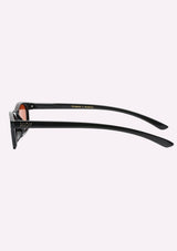 [Color: Black] A pair of slim, rectangle black acetate frames with amber lenses. Made by INDY