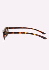 [Color: Espresso] A pair of slim, rectangle amber tortoise acetate frames with amber lenses. Made by INDY