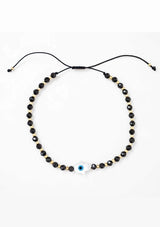 [Title: Black Onyx]  An adjustable healing bracelet, crafted on a durable nylon cord with a mother of pearl hamsa stone, gold-plated hardware and black natural gemstones. Designed by Kindred Row.
