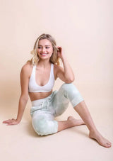 [Color: White] A comfortable white stretchy ribbed knit top with a racerback. 