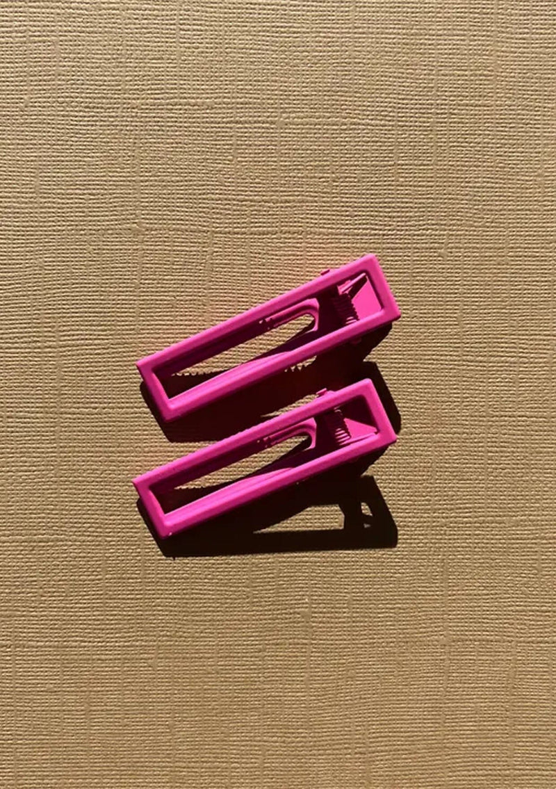 [Color: Hot Pink] A hot pink alligator hair clip. Comes in a set of two.