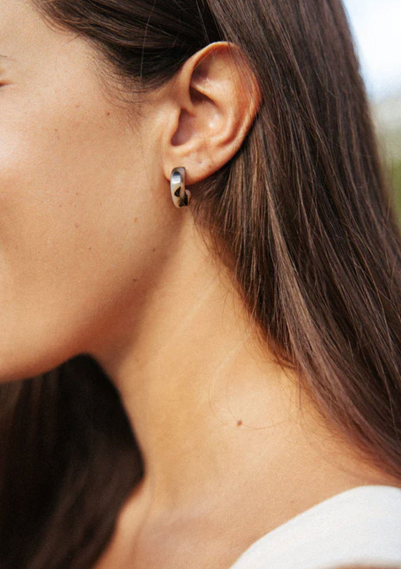 [Color: Ivory] A small ivory and brown acetate hoop earring. 